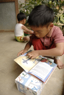 Child reading gospel tract from Operation Christmas Child
