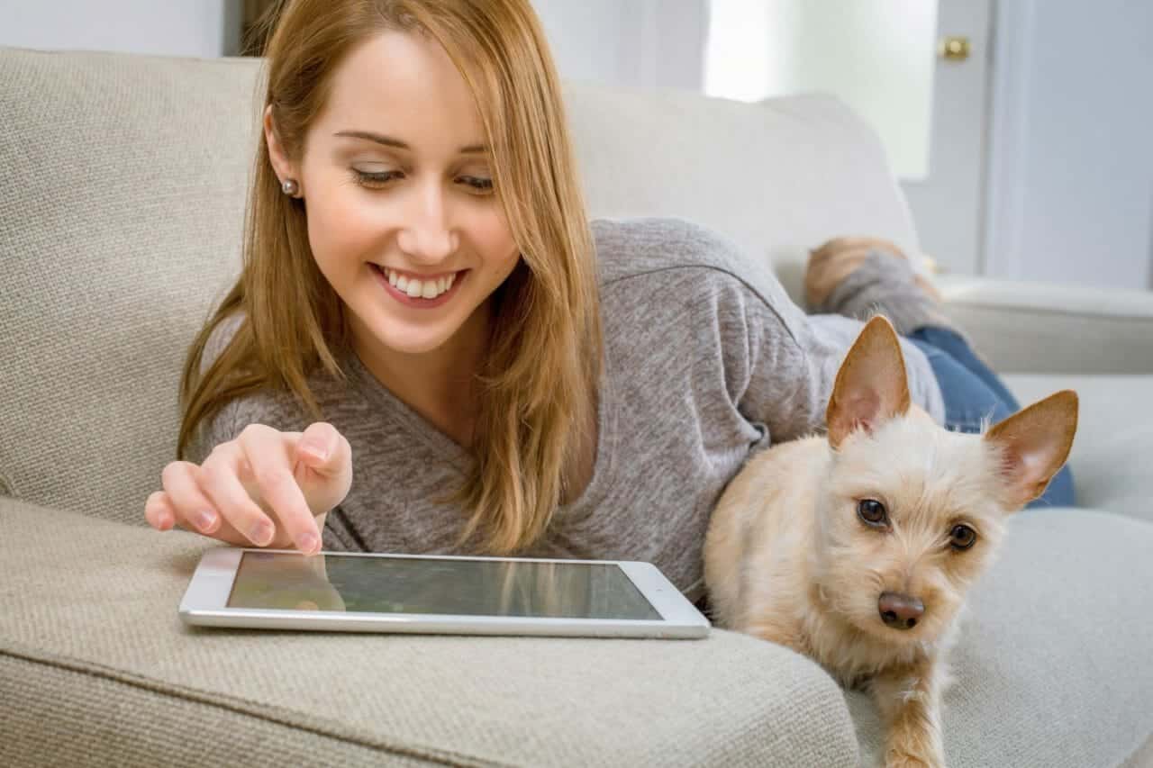 teenage daughter on tablet with dog