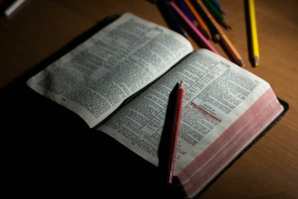 Bible & colored pencils sitting on a table