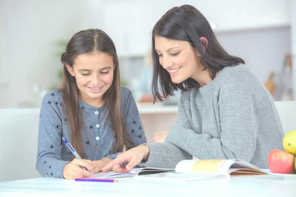 Mother helping her daughter with homework