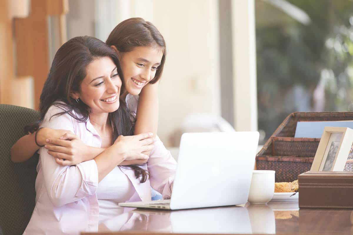Mother and daughter looking at a laptop screen