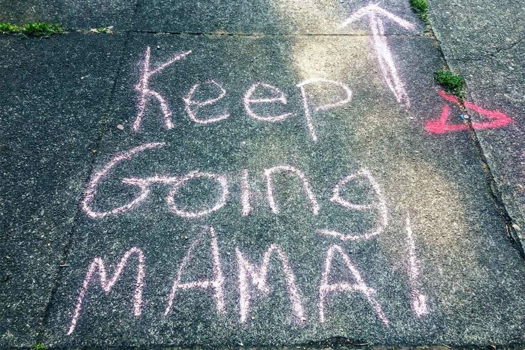 Keep Going Mama written in sidewalk chalk