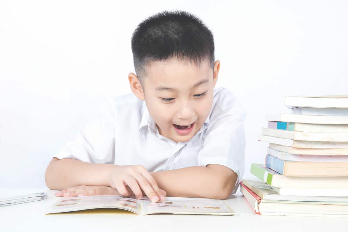 Little boy excited about something he read in a book