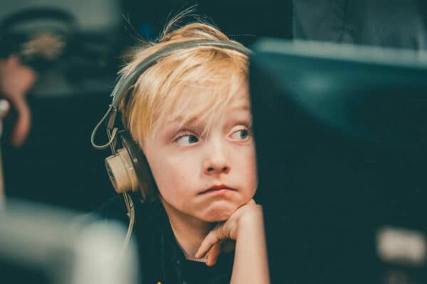 Boy at computer wearing headphones