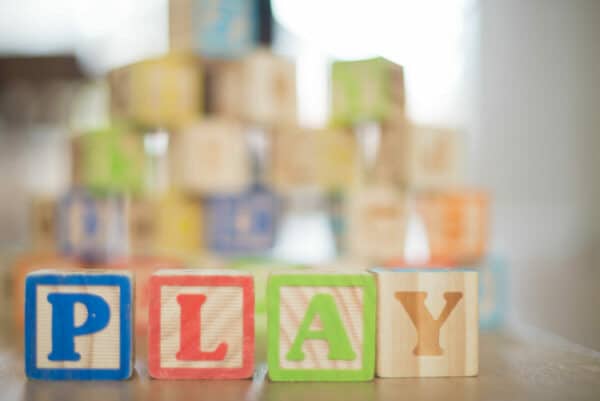 "Play" spelled out with alphabet blocks